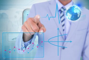 composite of businessman pointing at graphics